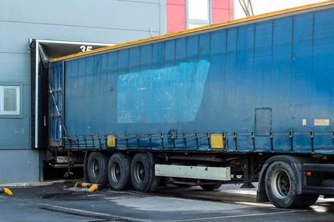 Trucks while loading in a big distribution warehouse. logistic import export and Stock Photos