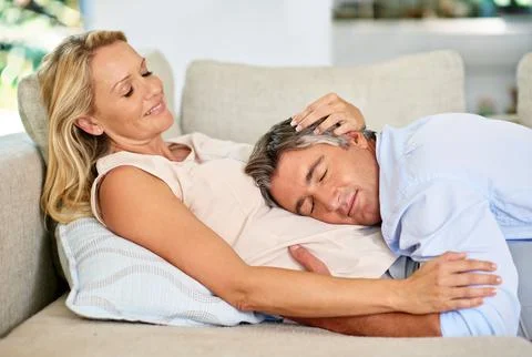 True devotion. a mature couple sharing a tender moment together while relaxing Stock Photos