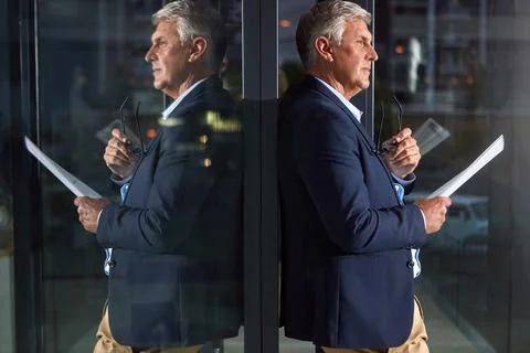True leaders lead by example. a dedicated businessman working alone in his Stock Photos