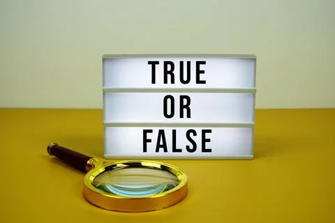 True or False text on light box with magnifying glass on yellow background Stock Photos