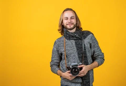 A true shutterbug. Photographer yellow background. Photographer hold photo Stock Photos