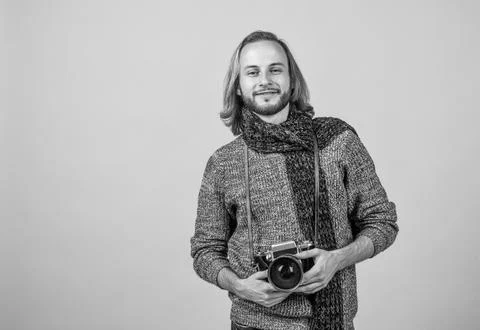 A true shutterbug. Photographer yellow background. Photographer hold photo Stock Photos