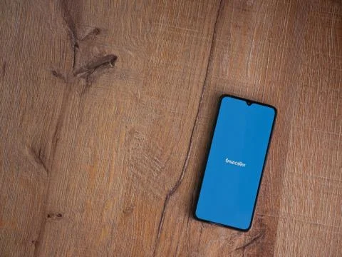 Truecaller app launch screen with logo on the display of a black mobile smart Stock Photos