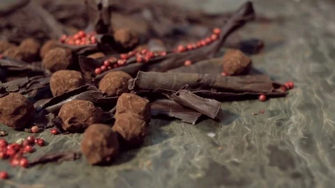 Truffles in dark chocolate with red pepper and chocolate chips. Видео 74567372
