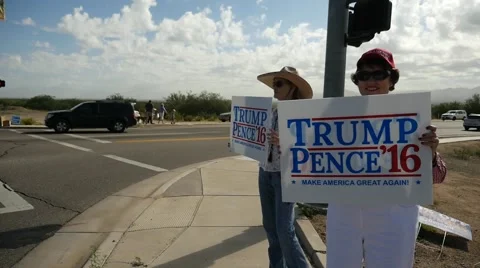 Trump supporters holding signs at an intersection Stock Footage