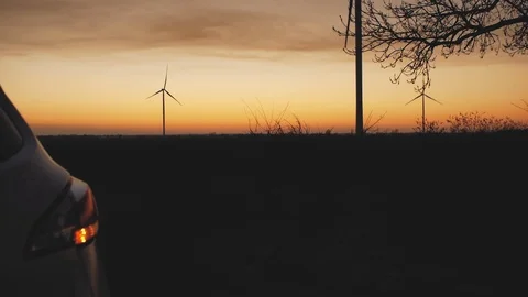 The trunk of the car opens automatically against the background of sunset and Stock Footage 103218163