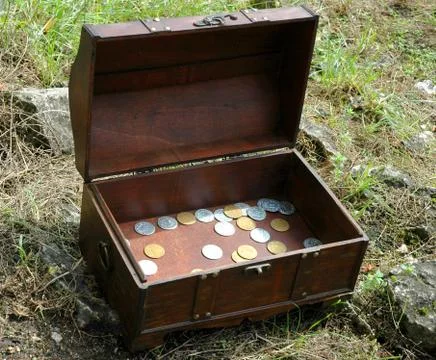 Trunk with coins Stock Photos