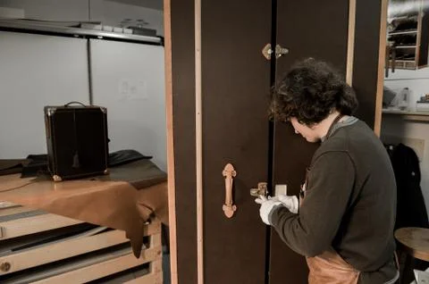 Trunk Maker at work in his luxury leather workshop 写真素材