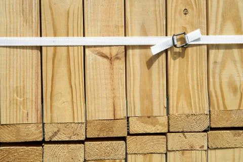 Trusses stack closeup at construction site, white nylon belt, steel buckle Stock Photos