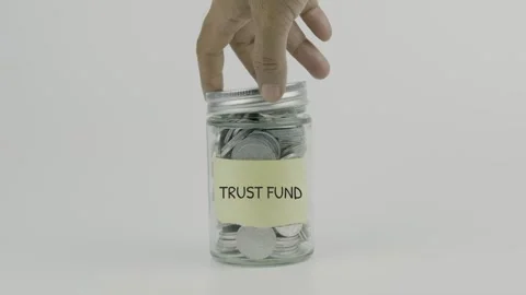 Trust fund text or word on yellow sticky notes attached to a coin jar Stock Footage 307182846