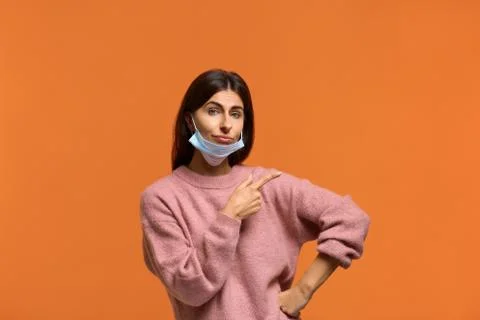 Trust me it will help. Portrait of confident female put medical mask on the c Stock Photos