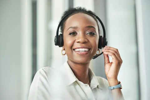 Trust me to solve your problems. an attractive young call centre agent sitting Stock Photos