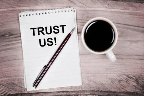 Trust us words on notebook Stock Photos