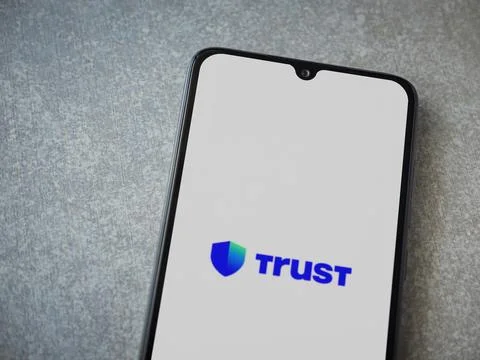 Trust Wallet app launch screen on smartphone on ceramic stone background Stock Photos