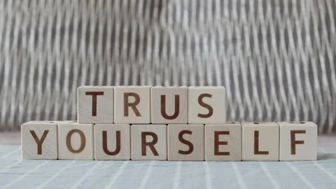 Trust yourself, laying out  by hand from letters on wooden cubes Stockbeeldmateriaal 342134488