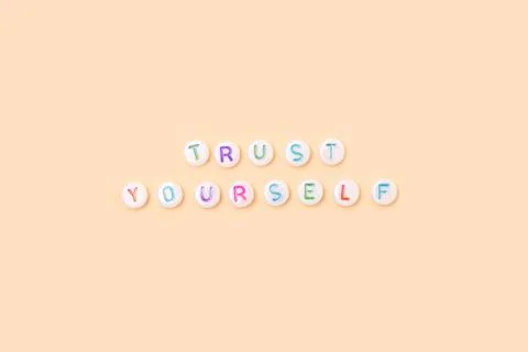 Trust yourself. Quote made of white round beads with colorful letters. Stock Photos