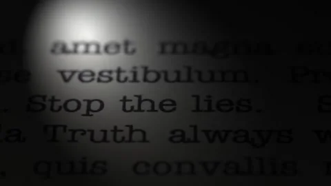 Truth always wins. Stop the lies. Moving text printed on a page. Slow motion. Stock Footage 307286206
