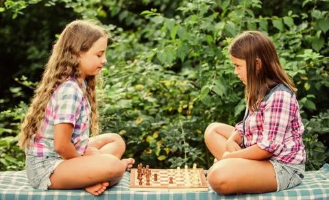 Try to beat me. chess playing sisters. skilled children. turn on your brain Stock Photos