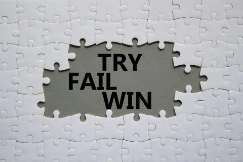 Try Fail Win symbol. Concept words Try Fail Win on white puzzle. Beautiful .. Stock Photos