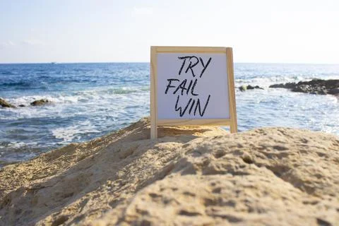 Try Fail Win symbol. White Blackboard with words Try Fail Win. Beautiful se.. Stock Photos