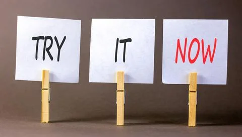 Try it now words symbol. Concept words Try is now on beautiful white papers.. Stock Photos