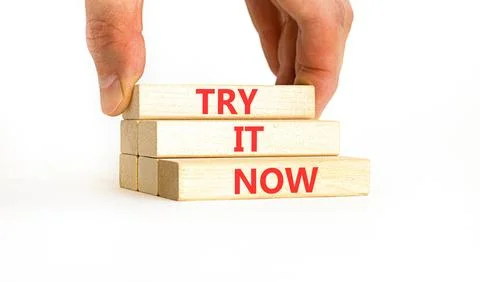 Try it now words symbol. Concept words Try is now on beautiful wooden block.. Stock Photos