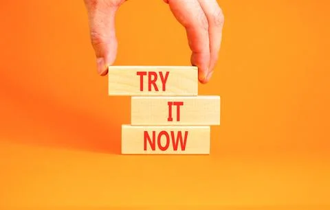 Try it now words symbol. Concept words Try is now on beautiful wooden block.. Stock Photos