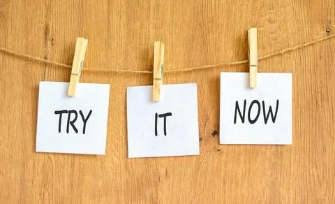 Try it now words symbol. Concept words Try is now on beautiful white papers.. Stock Photos