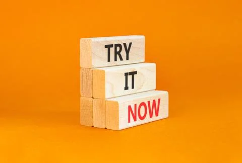 Try it now words symbol. Concept words Try is now on beautiful wooden block.. Stock Photos