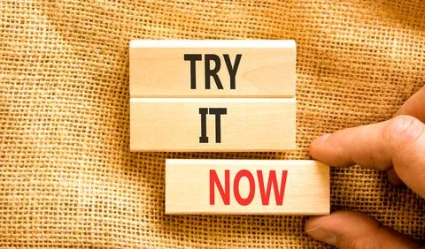 Try it now words symbol. Concept words Try is now on beautiful wooden block.. Stock Photos