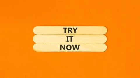 Try it now words symbol. Concept words Try is now on beautiful wooden stick.. Stock Photos