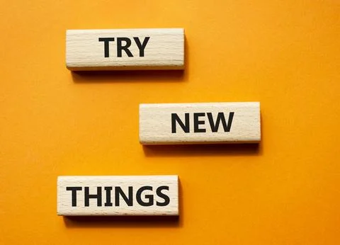 Try new Things symbol. Concept words Try new Things on wooden blocks. Beaut.. Stock Photos