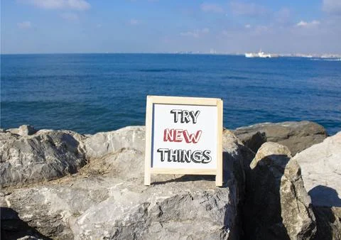 Try new Things symbol. Concept words Try new Things on white chalk blackboa.. Foto stock