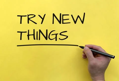 Try new things text on yellow background cover. Conceptual Stock Photos