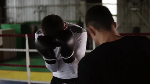 Try to protect, guard. Sparring, training of two young partners of boxers on the Stock Footage 102723369
