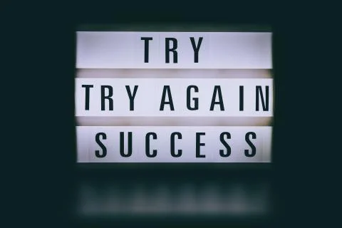 Try try again success message on lightbox in the dark Stock Photos