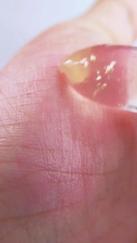 Trying to apply pink lip balm on palm. Extreme close up showing hand starti.. Stock Footage 339061910