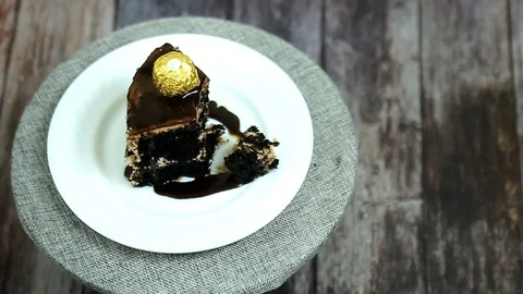 Trying a bite from havenly chocolate cake slice  Stock Footage 108440309