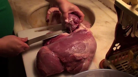 Trying to butcher meat with dull knife Stock Footage 33653318