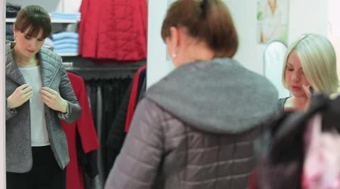 Trying on clothes in front of a mirror in the store Stock Footage 61133447