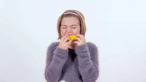 Trying to eat a lemon Stock Footage 83724878