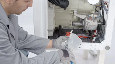 Trying to find out where a problem is with a washing machine Stock Footage 85831915