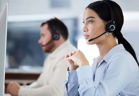 Trying to find where the problem is. an attractive young call centre agent Stock Photos