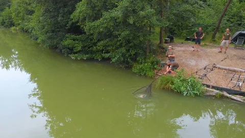 Trying to get a fish out of the water and it is still moving Stock Footage 112179425
