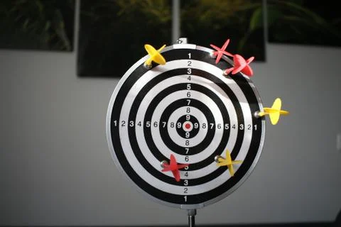 Trying to hit the dartboard Stock Photos