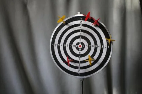 Trying to hit the dartboard Stock Photos