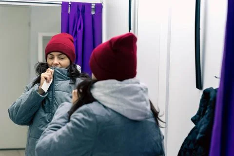 Trying on Jacket and Hat - Middle-aged Woman in Fitting Room of Pick-Up Point Stock Photos