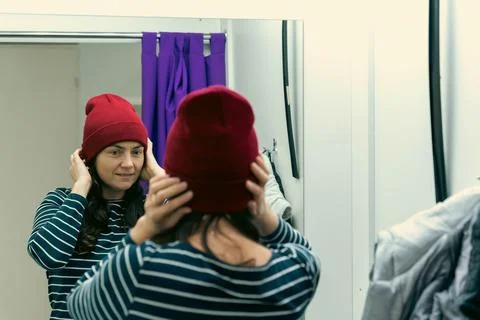 Trying on Jacket and Hat - Middle-aged Woman in Fitting Room of Pick-Up Point Foto stock