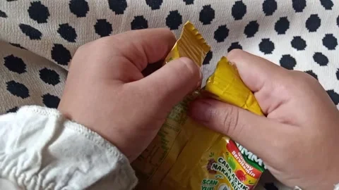 Trying To Open A Yellow Package Stock Footage 327509262
