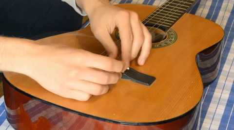 Trying To Re-String Classic Guitar Stock Footage 65790343